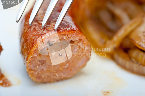 Image of beef sausages cooked on iron skillet 