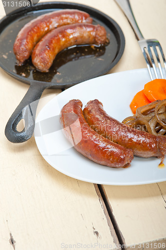 Image of beef sausages cooked on iron skillet 