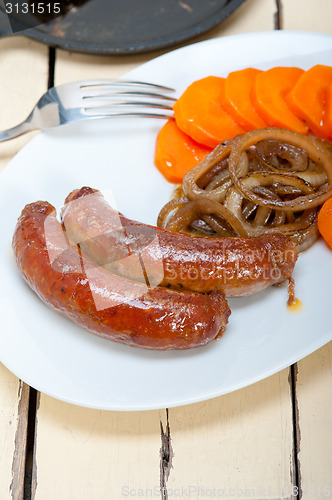 Image of beef sausages cooked on iron skillet 