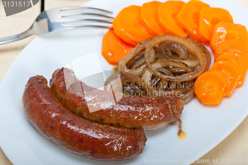 Image of beef sausages cooked on iron skillet 