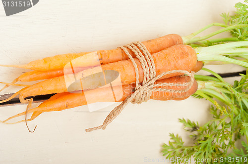 Image of baby carrots bunch tied with rope