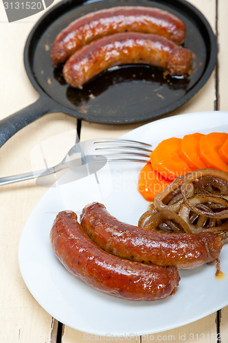 Image of beef sausages cooked on iron skillet 