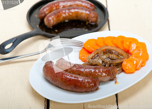 Image of beef sausages cooked on iron skillet 