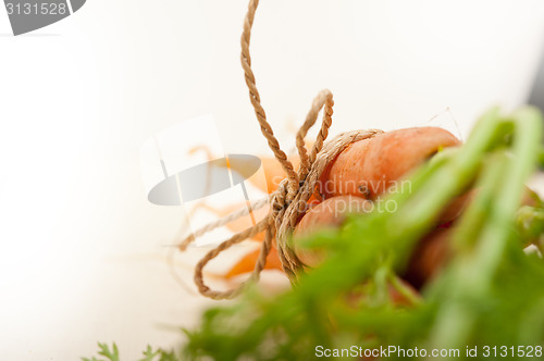 Image of baby carrots bunch tied with rope