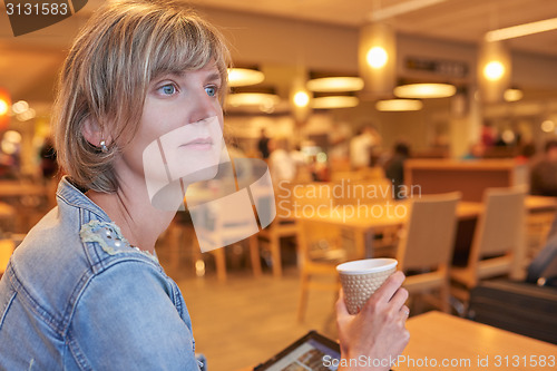 Image of Woman sitting in the cafe