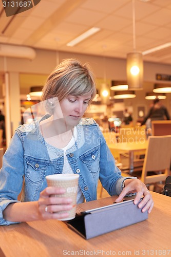 Image of Woman sitting in the cafe