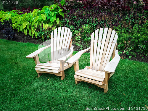 Image of Wooden chairs on green lawn