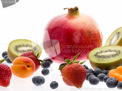 Image of Halved Kiwi Fruits And Berries On White Background