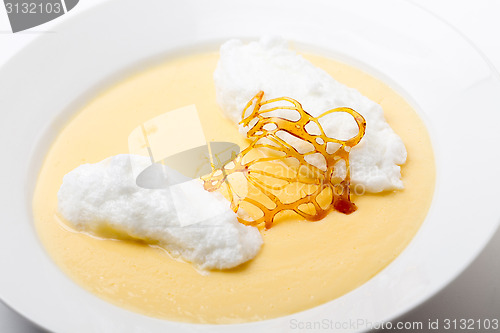 Image of Poached meringe on custard