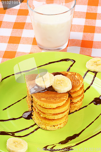 Image of Heart shaped pancakes with chocolate and banana