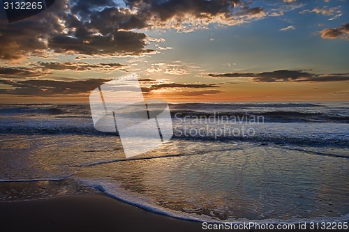 Image of Sunset over sea with clouds