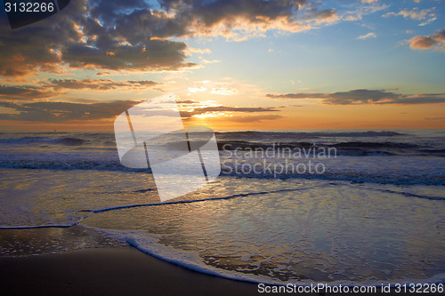 Image of Sunset over sea with clouds