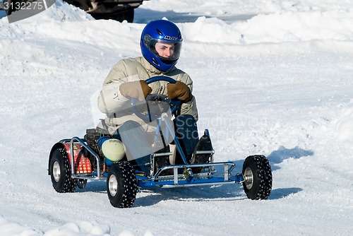 Image of Man is driving Go-kart with speed on karting track