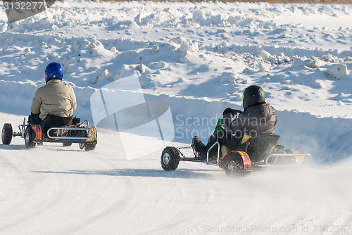 Image of Man is driving Go-kart with speed on karting track