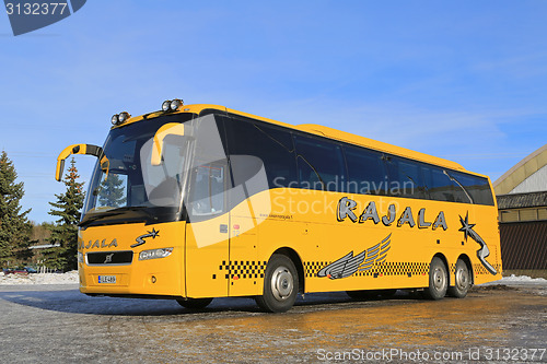 Image of Yellow Volvo Coach Bus Parked in Winter