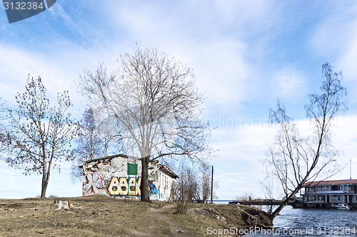 Image of Abandoned house on blue sky backgropund in spring