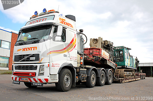 Image of Volvo FH16 Truck Hauls Pile Driver on Double Drop Deck Trailer