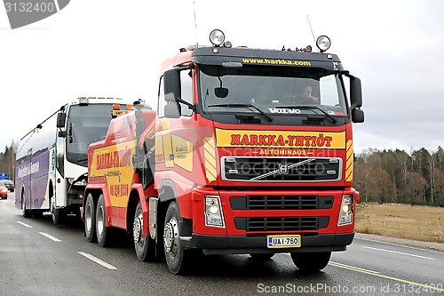 Image of Volvo FH13 Heavy Duty Tow Truck Tows a Bus