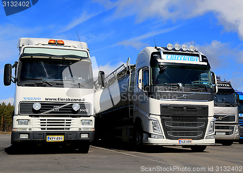 Image of Different Generations of Volvo FH Truck Parked in a Row