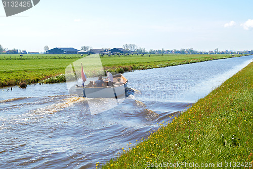 Image of Typical blue motor boat  in the Rural countryside  Netherlands