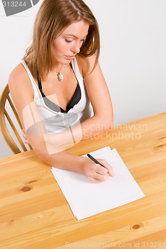 Image of young beautiful woman writing