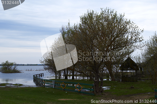 Image of Spring panorama with the river in flood cloudy day