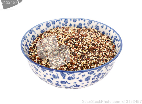 Image of Mixed red, white and black quinoa in a blue and white china bowl