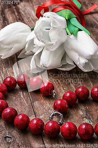 Image of tulips and womens coral beads