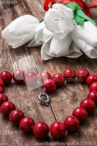 Image of tulips and womens coral beads