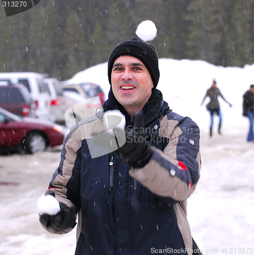 Image of Man juggle snowballs