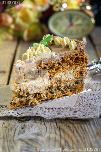 Image of Piece of walnut cake with cream close-up.