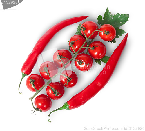 Image of Two chili pepper and cherry tomatoes on stem with parsley