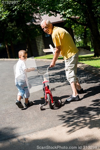 Image of grandfather and child have fun  in park