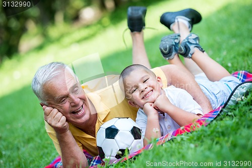 Image of grandfather and child have fun  in park