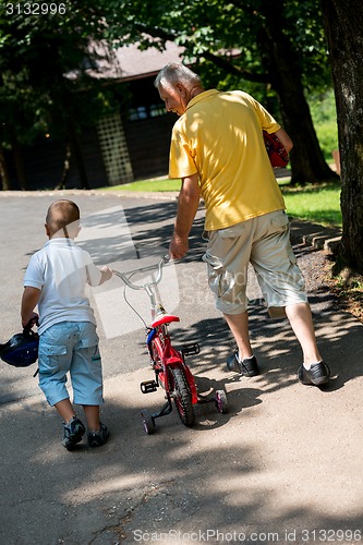 Image of grandfather and child have fun  in park