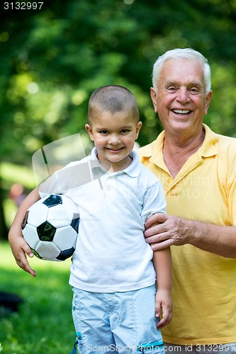 Image of grandfather and child have fun  in park