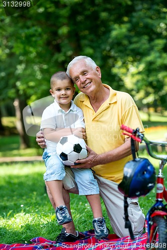 Image of grandfather and child have fun  in park