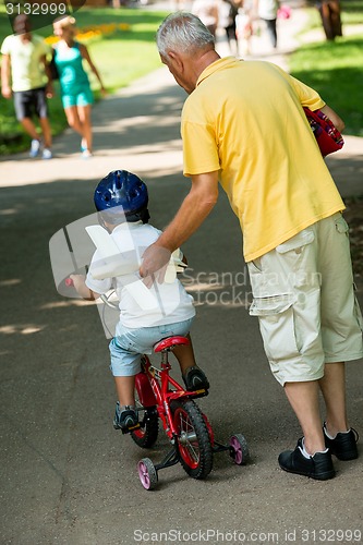 Image of grandfather and child have fun  in park