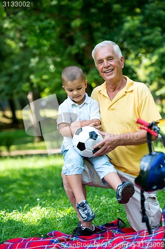 Image of grandfather and child have fun  in park