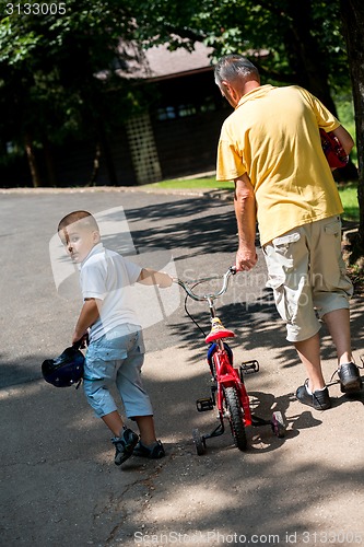 Image of grandfather and child have fun  in park