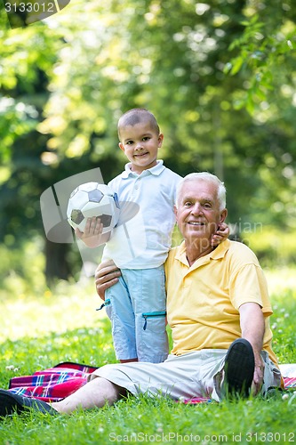 Image of grandfather and child have fun  in park