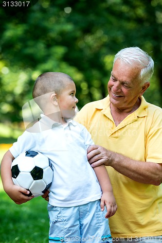 Image of grandfather and child have fun  in park