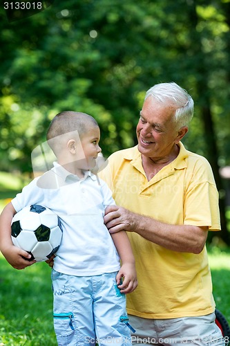 Image of grandfather and child have fun  in park