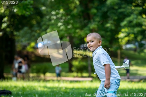 Image of boy with airpane toy