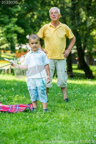 Image of grandfather and child have fun  in park