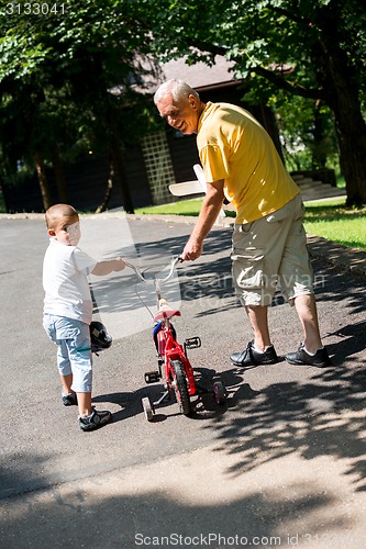 Image of grandfather and child have fun  in park