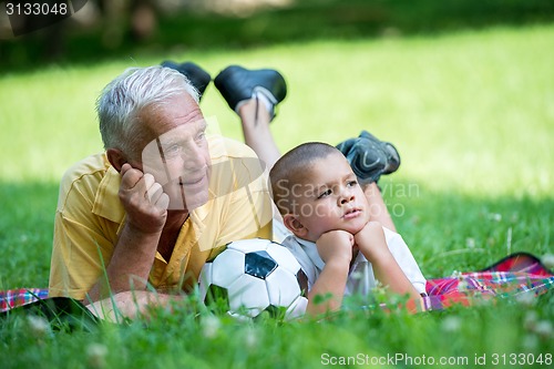 Image of grandfather and child have fun  in park