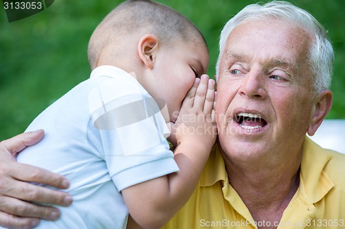 Image of grandfather and child have fun  in park