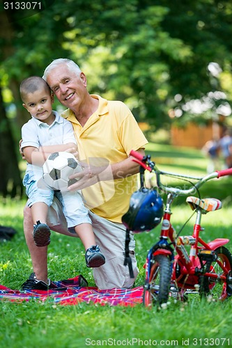 Image of grandfather and child have fun  in park