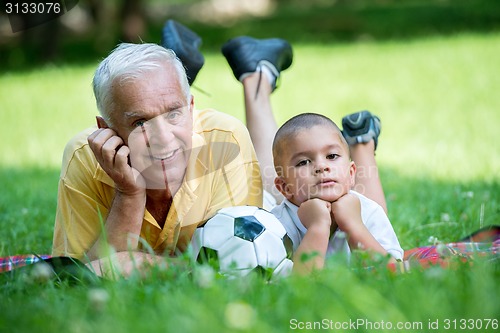 Image of grandfather and child have fun  in park